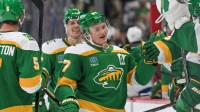 Minnesota Wild forward Kirill Kaprizov (97) is congratulated by teammates after taking sole possession as the franchise leader in goals on an empty netter against the Tampa Bay Lightning during the third period at Grand Casino Arena.