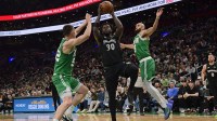 Minnesota Timberwolves forward Julius Randle (30) drives to the basket between Boston Celtics center Luka Garza (52) and guard Derrick White (9) during the second half at TD Garden.