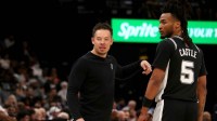 San Antonio Spurs head coach Mitch Johnson talks with guard Stephon Castle (5) during the second quarter against the Memphis Grizzlies at FedExForum.