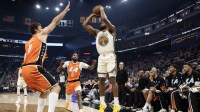 Golden State Warriors guard Moses Moody (4) shoots a three-point basket over Los Angeles Clippers center Brook Lopez (11) during the first quarter at Chase Center.