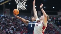 Utah State Aggies guard Elijah Perryman (1) shoots against Arizona Wildcats center Motiejus Krivas (13) in the second half during a second round game of the men's 2026 NCAA Tournament at Viejas Arena. Mandatory Credit: Kirby Lee-Imagn Images