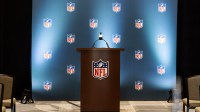 Detailed view of the NFL shield logo on a lectern in a press conference room during the 2026 NFL Annual League Meeting at the Arizona Biltmore.