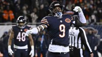 Chicago Bears safety Jaquan Brisker (9) fires up the crowd after a penalty call against the Green Bay Packers during the second half of an NFC Wild Card Round game at Soldier Field.