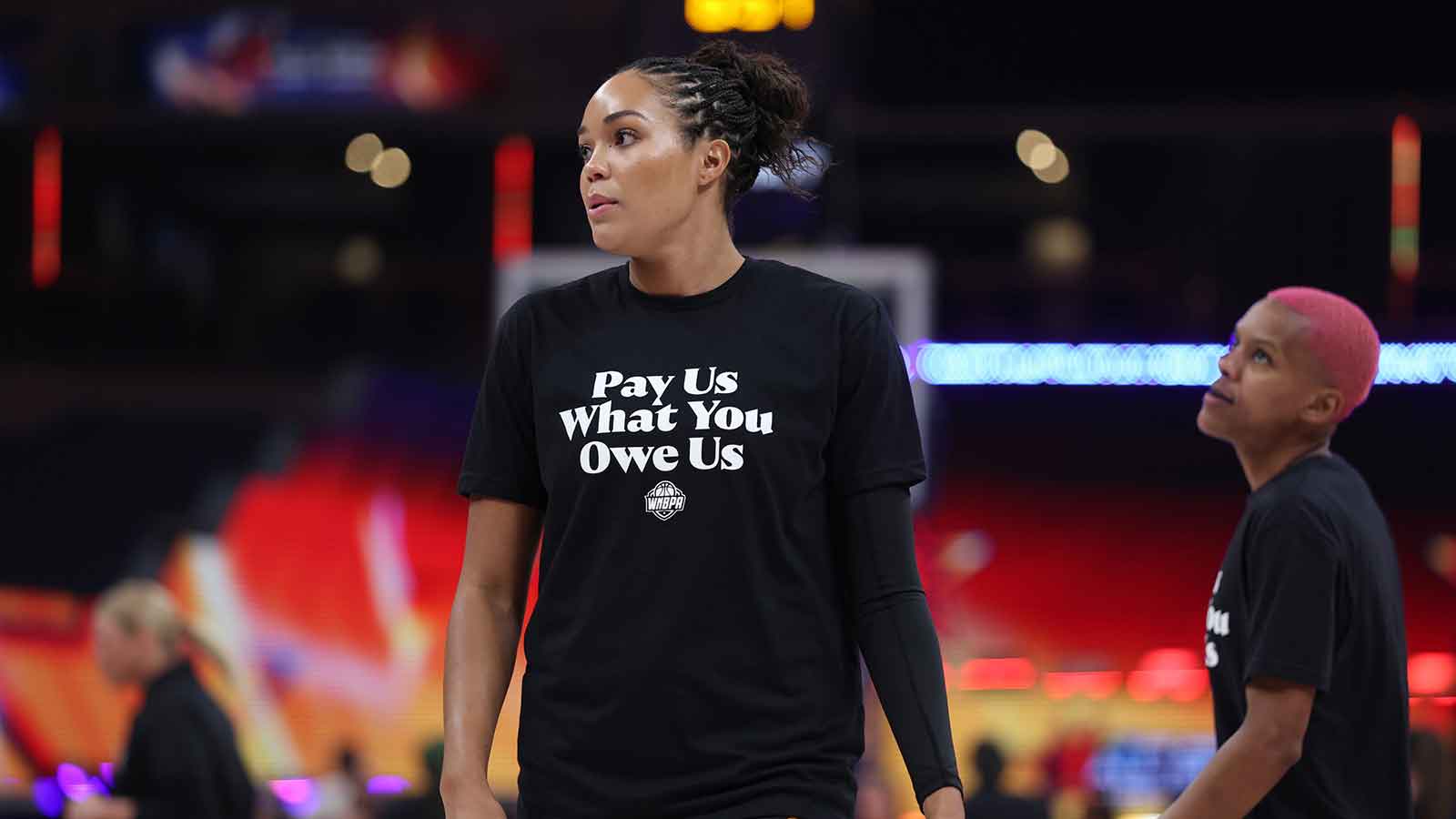 Team Collier forward Napheesa Collier (24) looks on with a "Pay Us" T-shirt before the 2025 WNBA All Star Game at Gainbridge Fieldhouse.