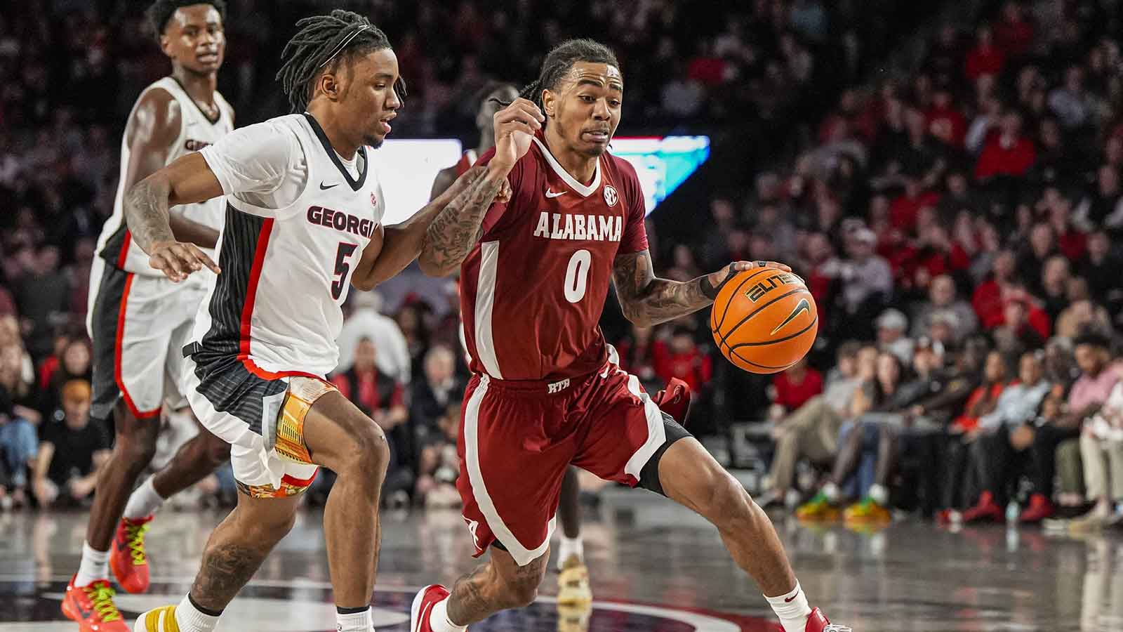 Alabama Crimson Tide guard Labaron Philon (0) dribbles against Georgia Bulldogs guard Jeremiah Wilkinson (5) at Stegeman Coliseum.