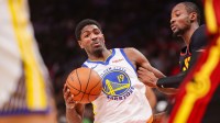 Golden State Warriors guard Nate Williams (19) is defended by Atlanta Hawks forward Jonathan Kuminga (0) in the third quarter at State Farm Arena.