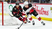 New Jersey Devils defenseman Simon Nemec (17) plays the puck against Ottawa Senators center Dylan Cozens (24) during the first period at Canadian Tire Centre.