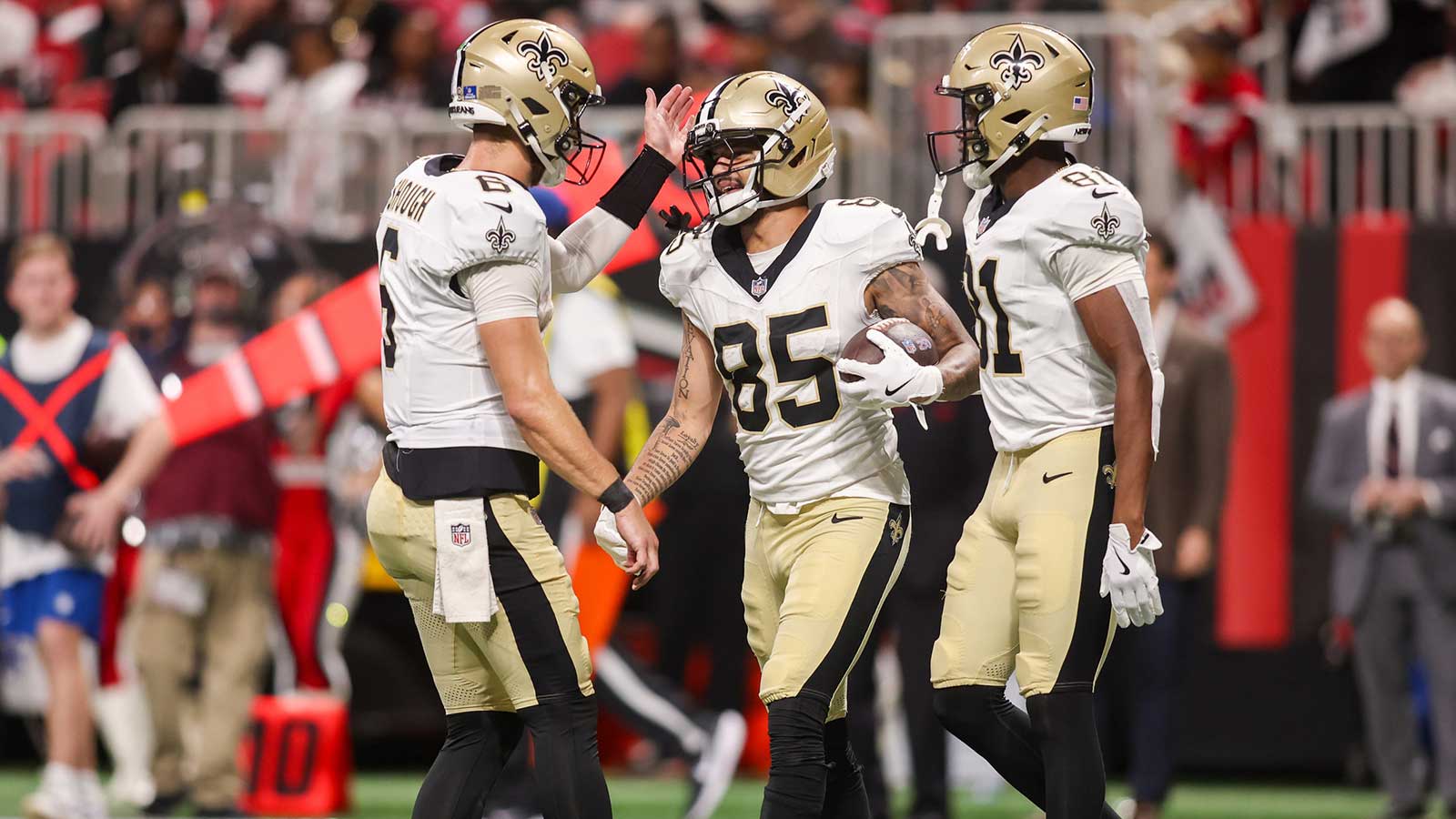 New Orleans Saints wide receiver Ronnie Bell (85) celebrates with quarterback Tyler Shough (6) and wide receiver Kevin Austin Jr. (81) after a touchdown against the Atlanta Falcons in the fourth quarter at Mercedes-Benz Stadium.