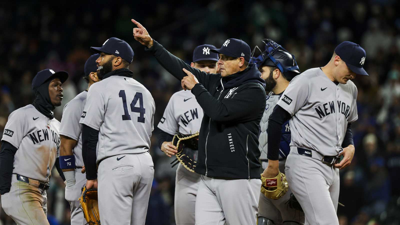 New York Yankees manager Aaron Boone (17) signals for a pitching change during the seventh inning against the Seattle Mariners at T-Mobile Park.