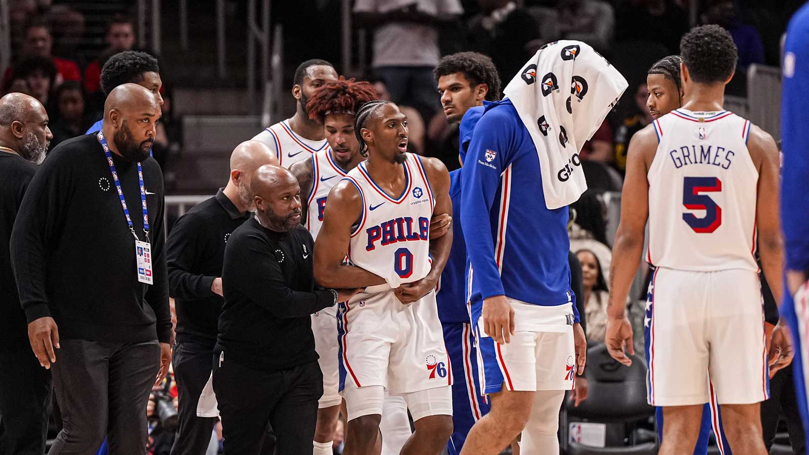 Philadelphia 76ers guard Tyrese Maxey (0) reacts and is assisted after being injured against the Atlanta Hawks during the second half at State Farm Arena.