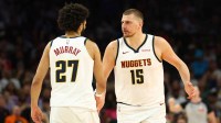 Denver Nuggets center Nikola Jokic (15) with guard Jamal Murray (27) against the Phoenix Suns in the second half at Mortgage Matchup Center.