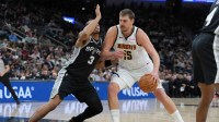Denver Nuggets center Nikola Jokic (15) dribbles against San Antonio Spurs forward Keldon Johnson (3) in the first half at Frost Bank Center. Mandatory Credit: Daniel Dunn-Imagn Images