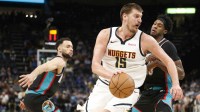 Denver Nuggets center Nikola Jokic (15) spins to the basket as Memphis Grizzlies forward Olivier-Maxence Prosper (18) defends during the fourth quarter at FedExForum.