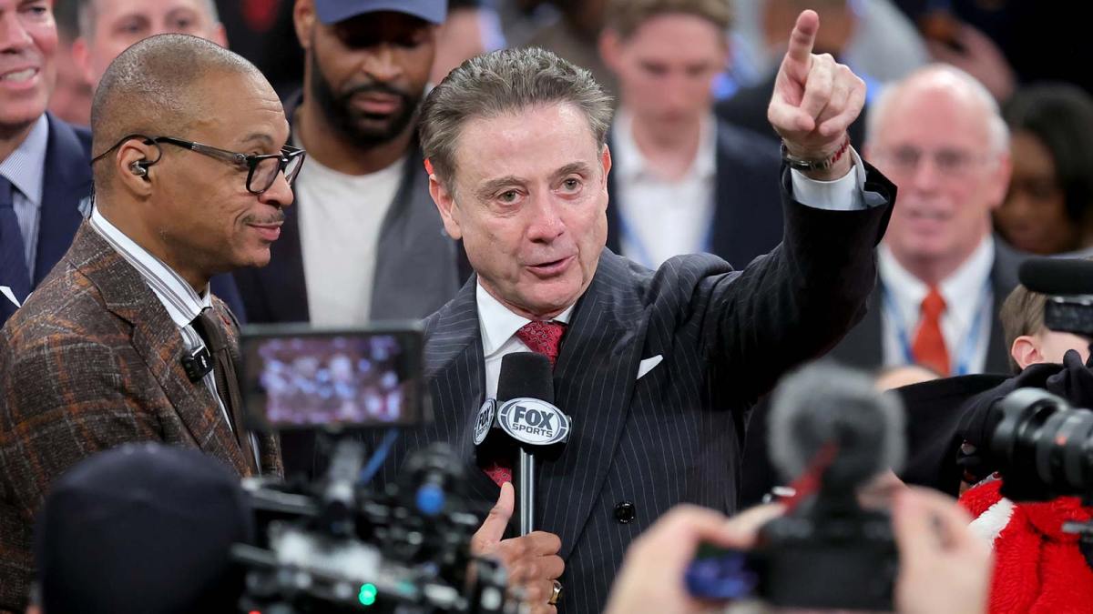 Fox Sports broadcaster Gus Johnson interviews St. John's Red Storm head coach Rick Pitino after St. John's defeats the Connecticut Huskies in the men's Big East Conference Tournament Championship game at Madison Square Garden.
