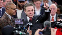 Fox Sports broadcaster Gus Johnson interviews St. John's Red Storm head coach Rick Pitino after St. John's defeats the Connecticut Huskies in the men's Big East Conference Tournament Championship game at Madison Square Garden.