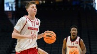 Wisconsin Badgers forward Nolan Winter (31) dribbles the ball during a practice session ahead of the first round of the men's 2026 NCAA Tournament.