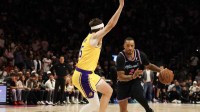 Miami Heat guard Norman Powell (24) drives to basket against Los Angeles Lakers guard Austin Reaves (15) during second half at Kaseya Center.