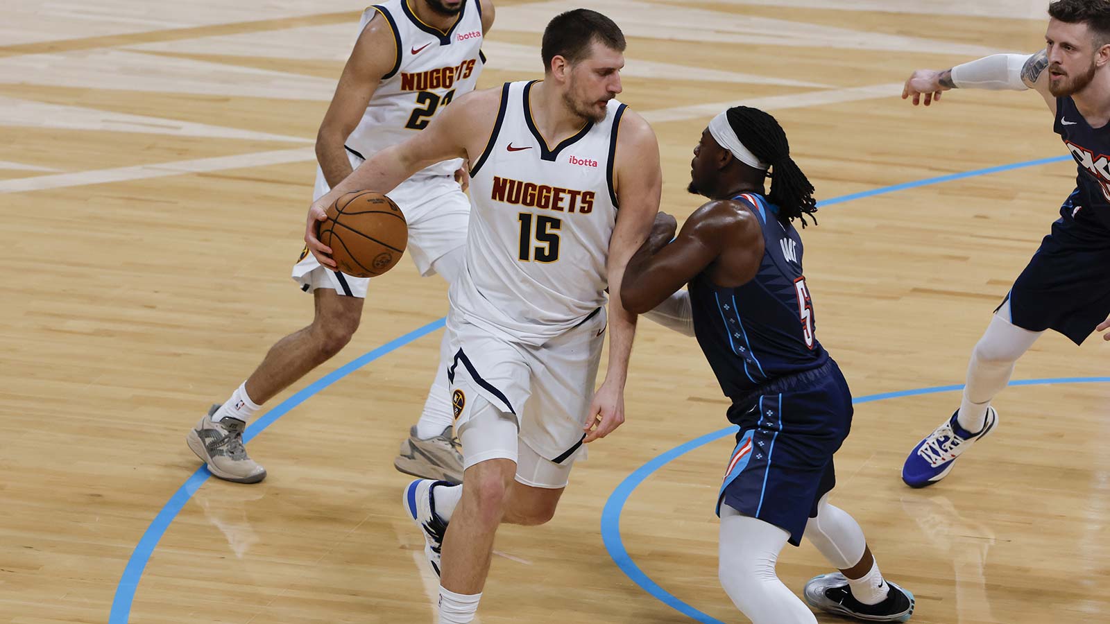 Nuggets center Nikola Jokić (15) drives against Oklahoma City Thunder guard Luguentz Dort (5) during the second quarter at Paycom Center