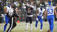 Chicago Bears wide receiver Rome Odunze (15) reacts after catching a pass against Los Angeles Rams safety Kam Curl (3) and linebacker Nate Landman (53) during the second quarter of an NFC Divisional Round game at Soldier Field.