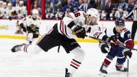 Chicago Blackhawks center Jason Dickinson (16) takes a shot on the net of the Colorado Avalanche during the first period at Ball Arena.