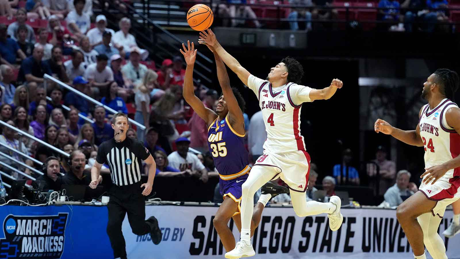 St. John's Red Storm guard Oziyah Sellers (4) and Northern Iowa Panthers forward Leon Bond III (35) reach for the loose ball in the first half during a first round game of the men's 2026 NCAA Tournament at Viejas Arena.