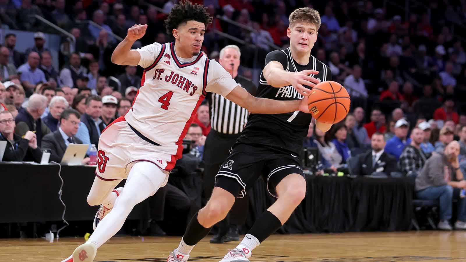 St. John's Red Storm guard Oziyah Sellers (4) and Providence Friars guard Stefan Vaaks (7) chase after a loose ball during the second half at Madison Square Garden.