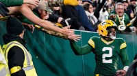 Green Bay Packers quarterback Malik Willis (2) high-fives fans after a touchdown during the third quarter against the Baltimore Ravens at Lambeau Field.