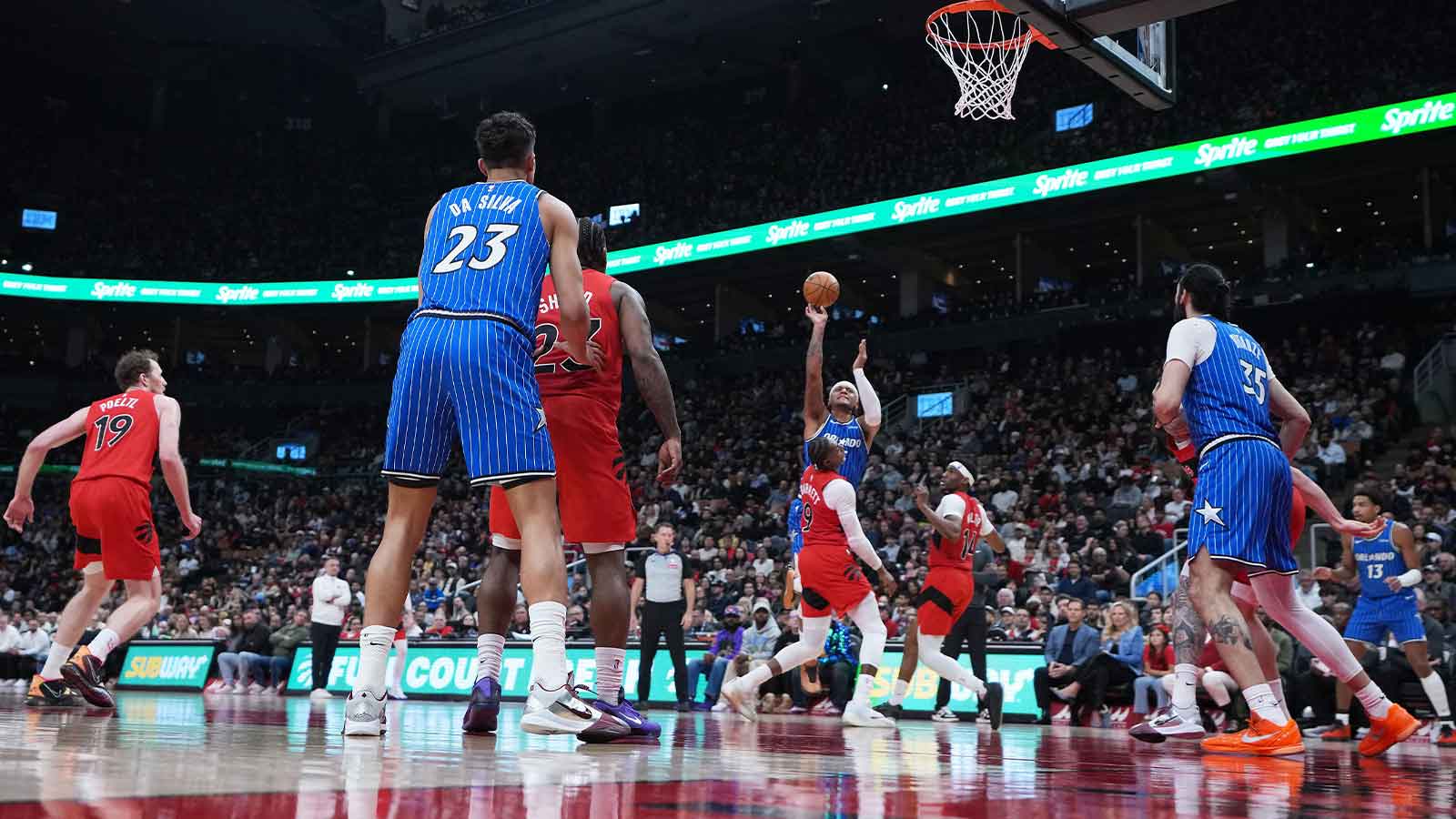 Orlando Magic forward Paolo Banchero (5) shoots the ball over Toronto Raptors forward RJ Barrett (9) during the second quarter at Scotiabank Arena.