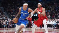 Orlando Magic forward Paolo Banchero (5) controls the ball as Toronto Raptors forward Scottie Barnes (4) tries to defend during the first quarter at Scotiabank Arena.