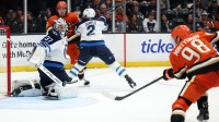 Winnipeg Jets goaltender Connor Hellebuyck (37) gives up a goal to Anaheim Ducks defenseman Pavel Mintyukov (98) during the third period at Honda Center.