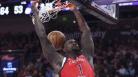 Pelicans forward Zion Williamson (1) dunks the ball against the Utah Jazz during the first half at Delta Center with ESPN's Stephen A Smith in the background