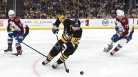 Pittsburgh Penguins center Sidney Crosby (87) moves the puck against Colorado Avalanche center Brock Nelson (11) and right wing Valeri Nichushkin (13) during the third period t PPG Paints Arena.
