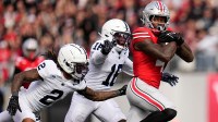Ohio State Buckeyes wide receiver Jeremiah Smith (4) catches a pass in front of Penn State Nittany Lions safety King MacK (16) and cornerback Audavion Collins (2) during the NCAA football game against the Penn State Nittany Lions at Ohio Stadium in Columbus on Nov. 1, 2025.