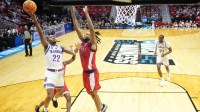 Kansas Jayhawks guard Darryn Peterson (22) shoots against St. John's Red Storm forward Zuby Ejiofor (24) in the second half during a second round game of the men's 2026 NCAA Tournament at Viejas Arena.