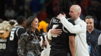 VCU Rams guard Terrence Hill Jr. (6) hugs VCU Rams head coach Phil Martelli Jr. after defeating the North Carolina Tar Heels in overtime of a first round game of the men's 2026 NCAA Tournament at Bon Secours Wellness Arena.