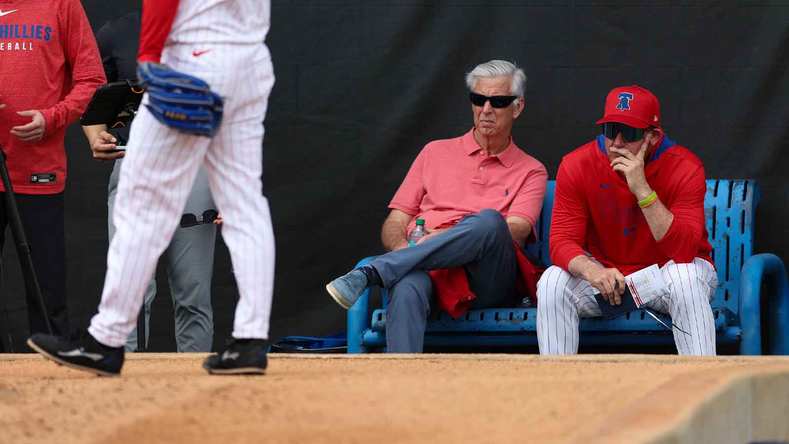 Philadelphia Phillies president of baseball operations Dave Dombrowski (left) and manager Rob Thomson (59) (right) watch buppben sessions spring training workouts at BayCare Ballpark.