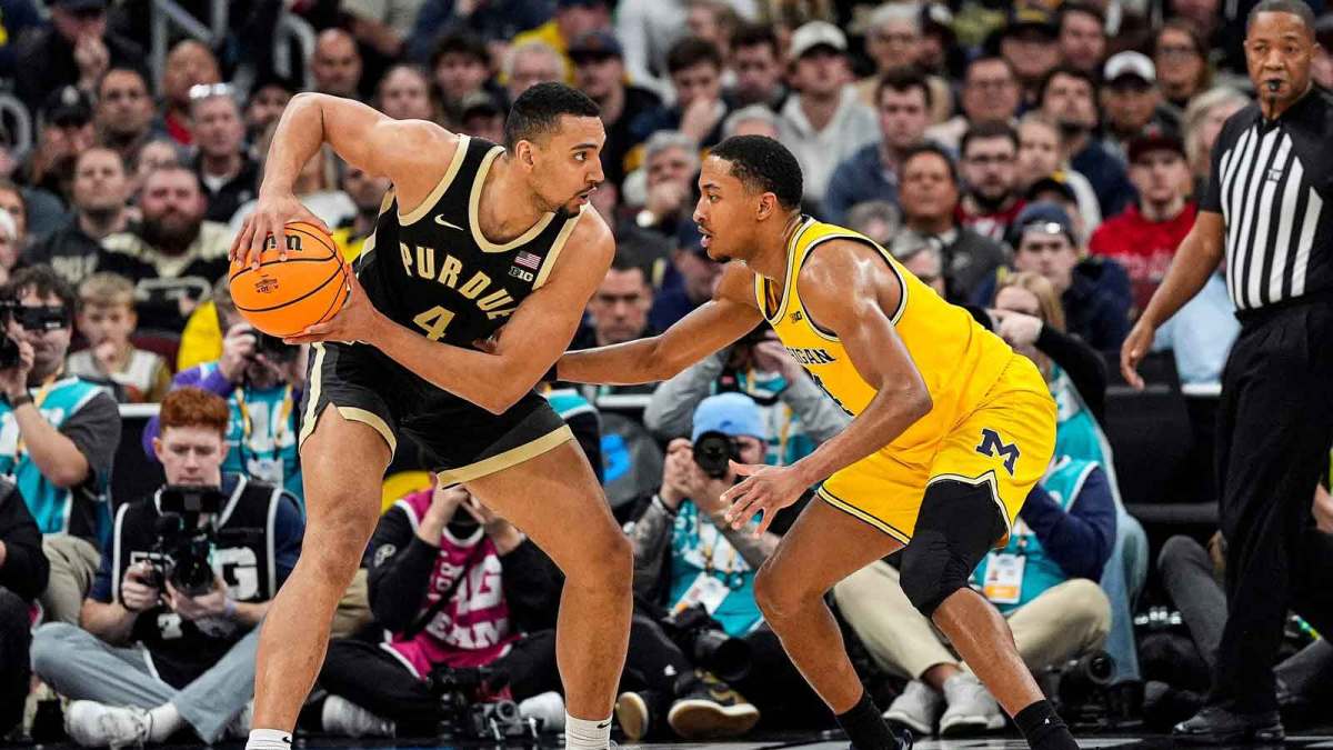 Purdue forward Trey Kaufman-Renn (4) looks to pass against Michigan guard Nimari Burnett (4) during the second half of Big Ten Tournament final at United Center in Chicago on Sunday, March 15, 2026.