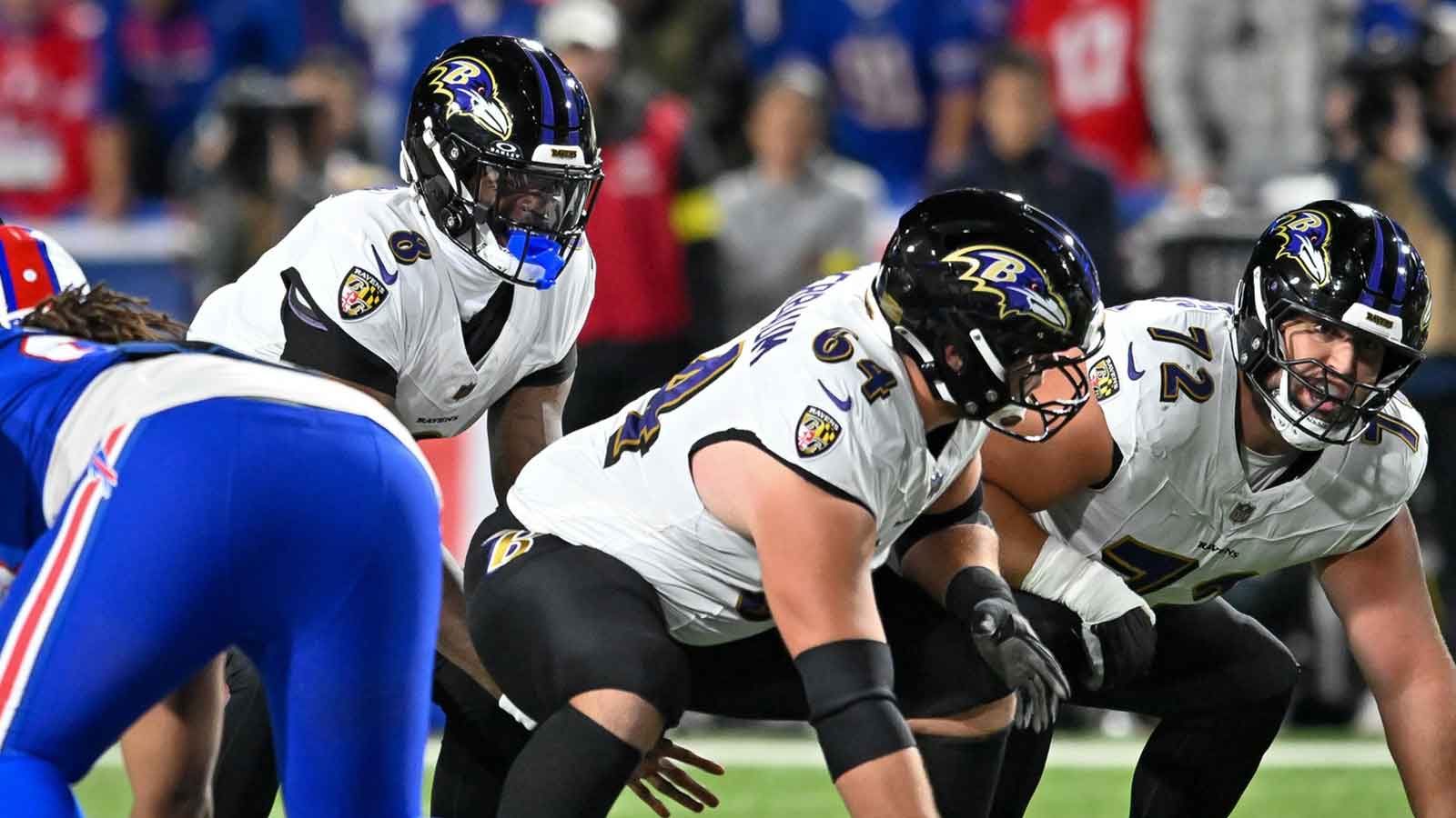 Baltimore Ravens quarterback Lamar Jackson (8) with center Tyler Linderbaum (64) and guard Andrew Vorhees (72) at the line of scrimmage in the first quarter against the Buffalo Bills at Highmark Stadium.