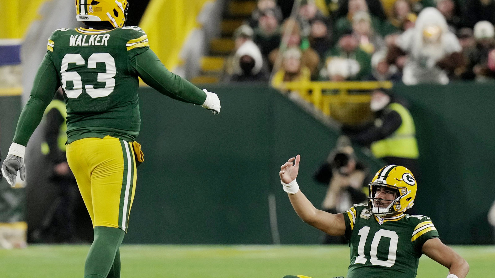 Green Bay Packers quarterback Jordan Love (10) is helped off the turf by offensive tackle Rasheed Walker (63) after being sacked during the first quarter of their game against the Philadelphia Eagles Monday, November 10, 2025 at Lambeau Field in Green Bay, Wisconsin.
