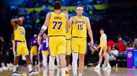 Los Angeles Lakers guard Luka Doncic (77) and guard Austin Reaves (15) react during the second half at Crypto.com Arena