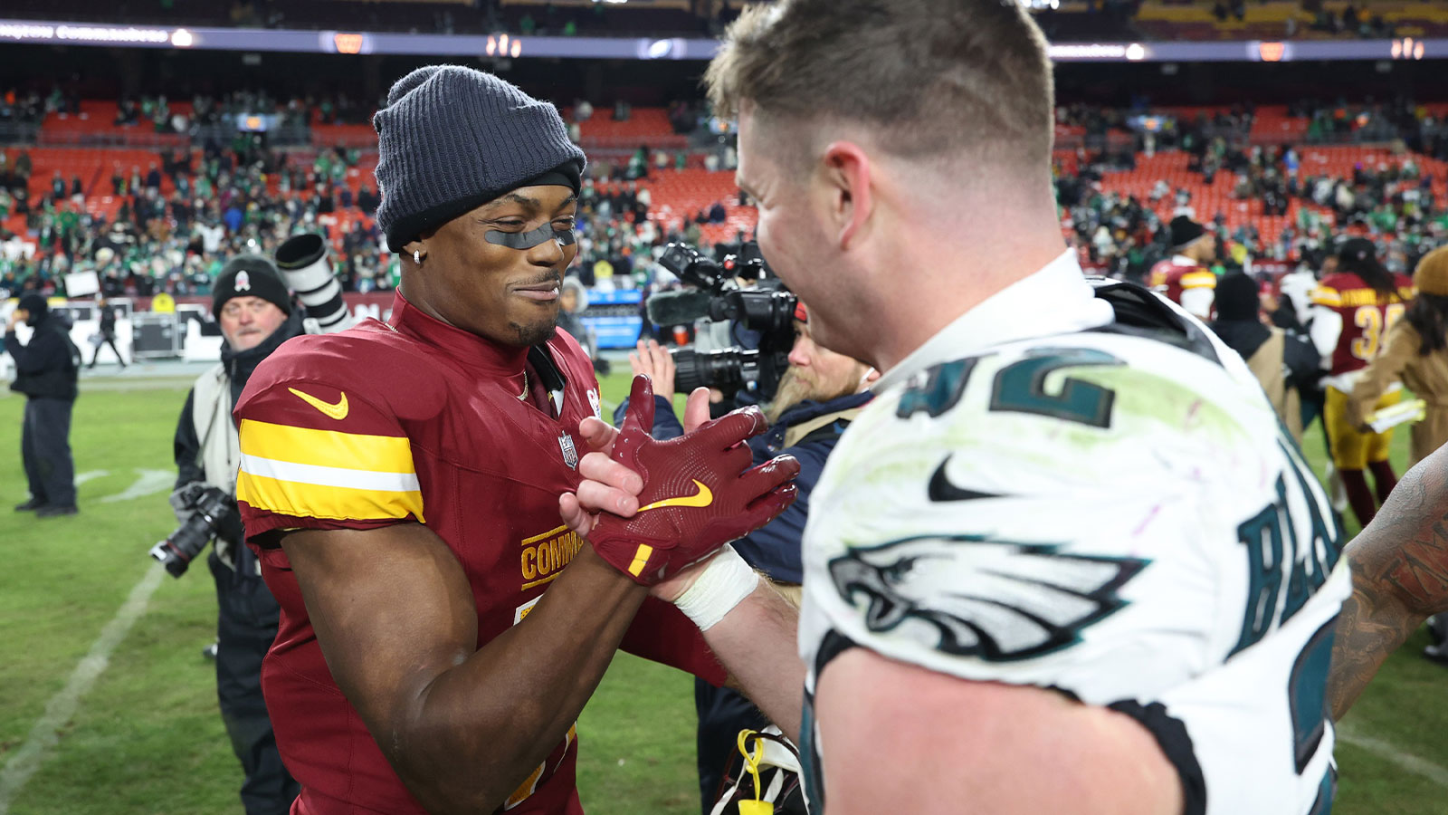 Washington Commanders wide receiver Terry McLaurin (17) greets Philadelphia Eagles safety Reed Blankenship (32) after the game at Northwest Stadium. 