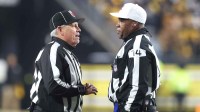 NFL line judge Jeff Seeman (left) and referee Shawn Smith (14) discuss a call during the fourth quarter between the Baltimore Ravens and the Pittsburgh Steelers at Acrisure Stadium.