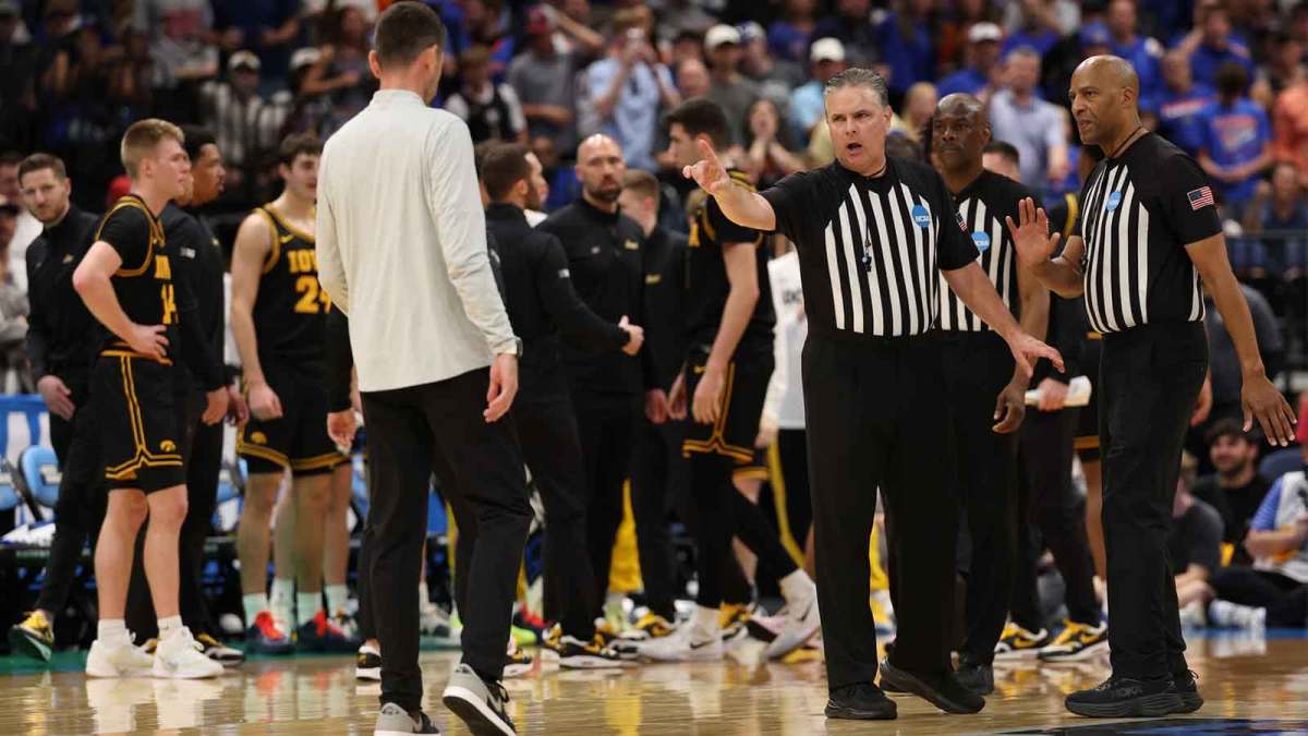 ; Referees talk to Florida Gators head coach Todd Golden after a fight against the Iowa Hawkeyes in the first half during a second round game of the men's 2026 NCAA Tournament at Benchmark International Arena.
