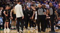 ; Referees talk to Florida Gators head coach Todd Golden after a fight against the Iowa Hawkeyes in the first half during a second round game of the men's 2026 NCAA Tournament at Benchmark International Arena.