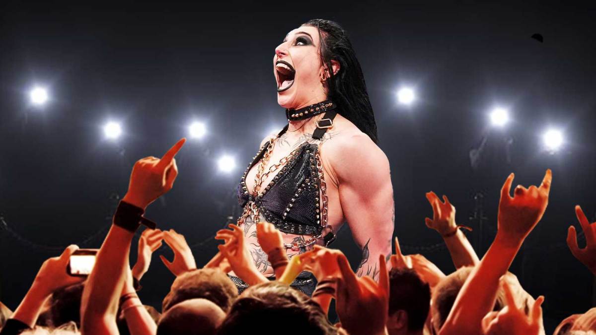 WWE star Rhea Ripley with fans around her.