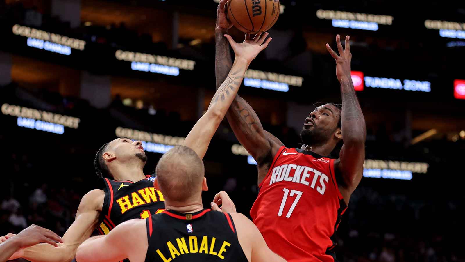 Houston Rockets forward Tari Eason (17) and Atlanta Hawks forward Zaccharie Risacher (10) battle for a rebound during the first quarter at Toyota Center.