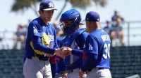 Los Angeles Dodgers starting pitcher Roki Sasaki (11) is taken out f the game by manager Dave Roberts (30) against the Cleveland Guardians during the first inning at Goodyear Ballpark.