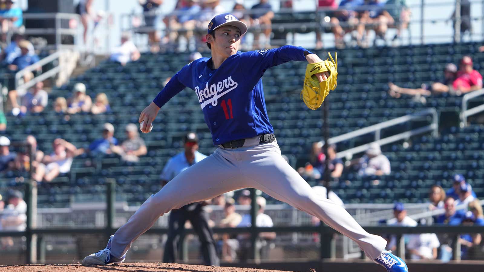 Los Angeles Dodgers starting pitcher Roki Sasaki (11) pitches against the Cleveland Guardians during the second inning at Goodyear Ballpark.