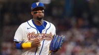 Venezuela outfielder Ronald Acuna Jr. (21) returns to the dugout against the Dominican Republic during the second inning at loanDepot Park.