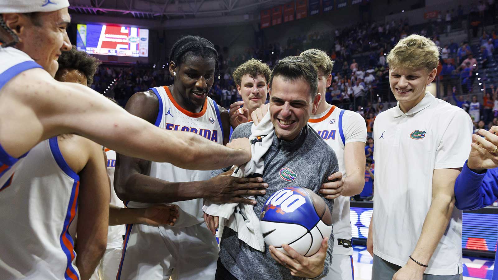 Florida Gators head coach Todd Golden celebrates his 100th win with center Viktor Mikic (12), center Rueben Chinyelu (9), center Micah Handlogten (3), forward Alex Condon (21) and forward Thomas Haugh (10) after the game against the Mississippi State Bulldogs at Exactech Arena at the Stephen C. O'Connell Center.